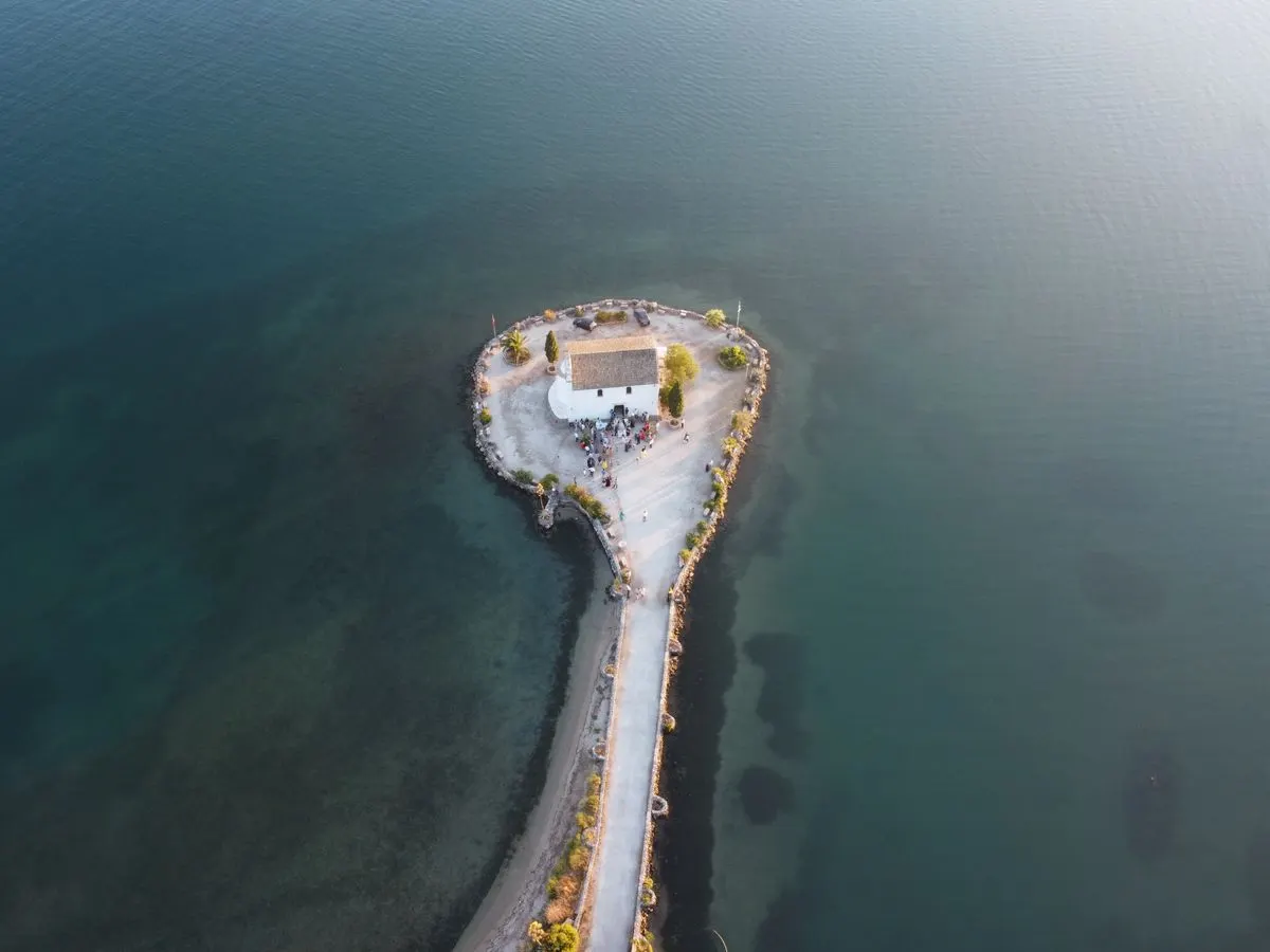 Discover the scenic beauty of the Ypapanti Church located on an islet in Corfu, Greece. - Photo…