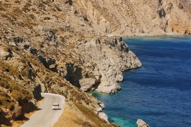 A serene drive along the rugged Greek coastline with sweeping sea views on a sunny day. - Photo…