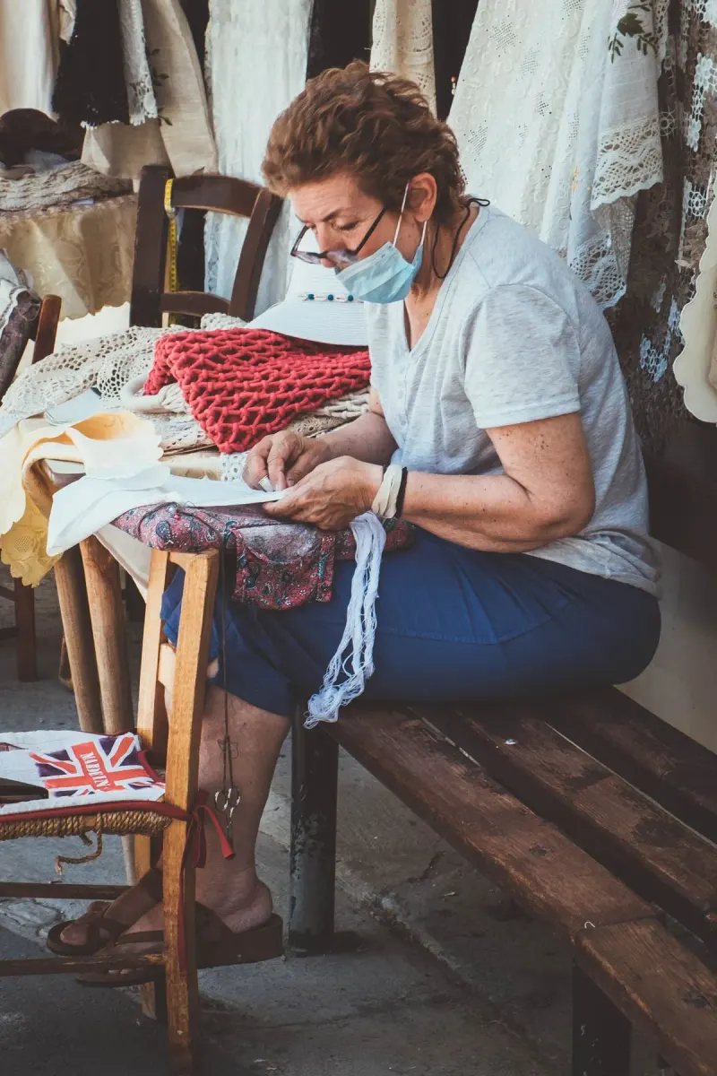 A vibrant local market scene with vendors selling diverse fresh produce and interacting with…