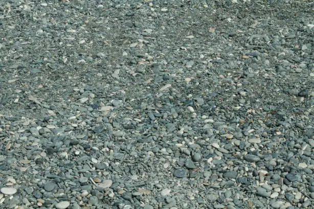 An expansive view of smooth pebbles and stones on a beach in Cyprus, ideal for backgrounds. -…