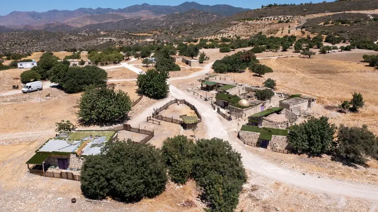 Explore the serene beauty of a traditional village in Cyprus from above. - Photo by Charis Ioil…