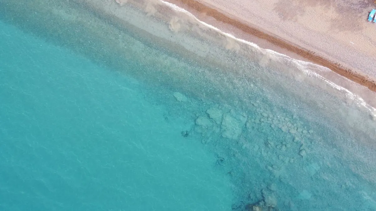 Drone shot showing the clear turquoise waters and sandy shore of Neo Chorio, Cyprus. - Photo by…