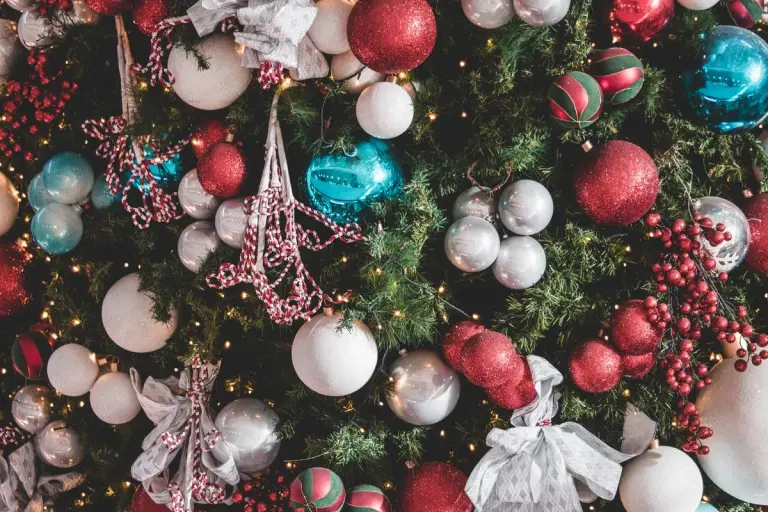 Festive Christmas tree adorned with colorful ornaments and twinkling lights, perfect for holiday…