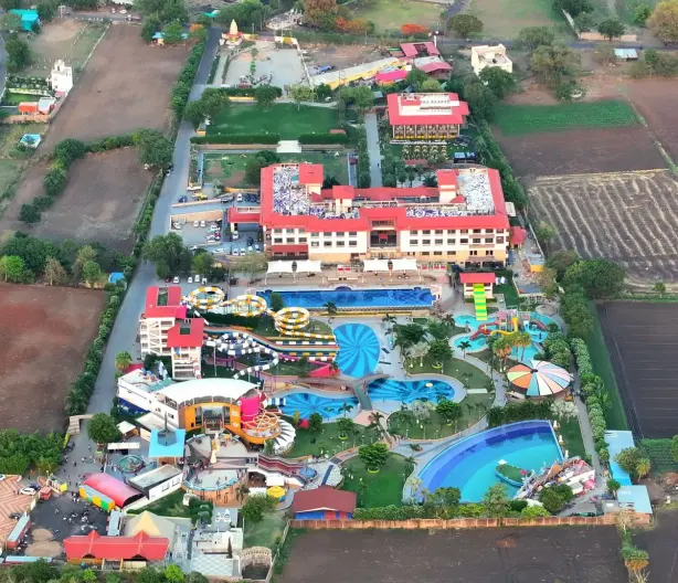 Aerial shot of a colorful waterpark surrounded by rural landscapes and fields. - Photo by Nilay…