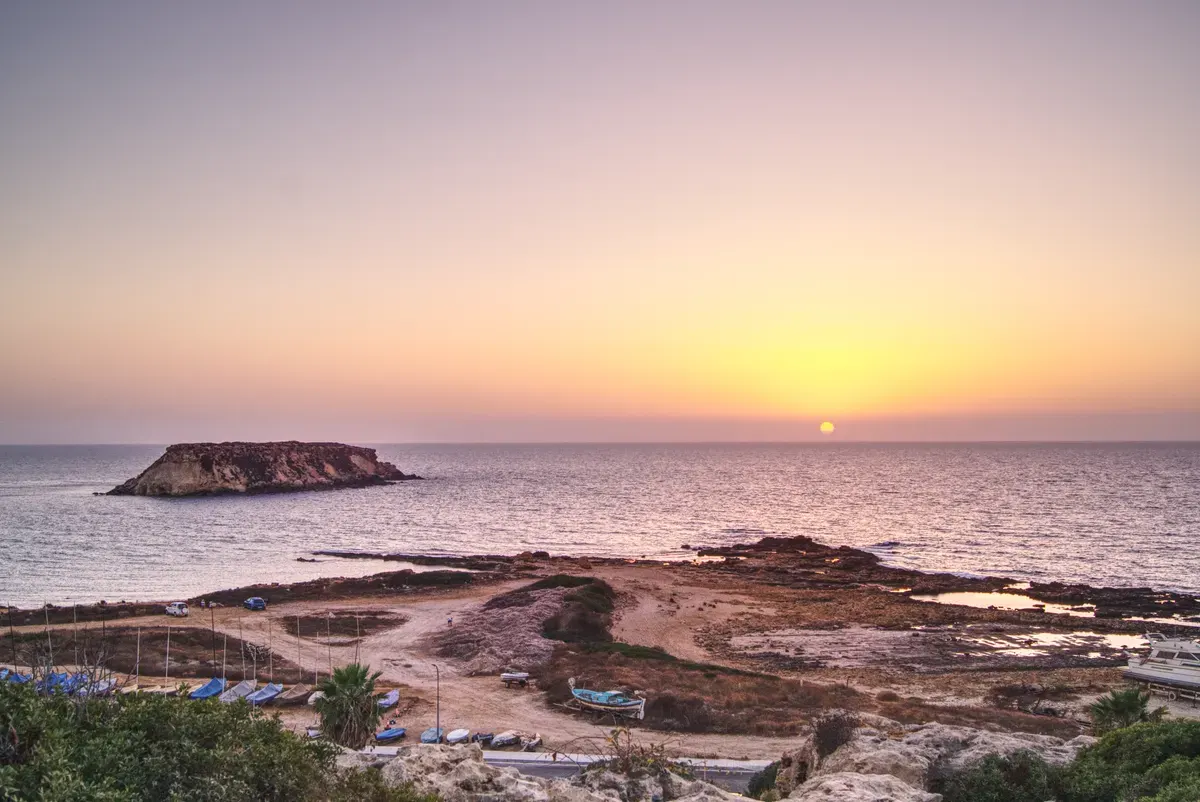 Tranquil sunset view over the sea and coastline in Paphos, Cyprus. - Photo by Anastasiia Voskova…