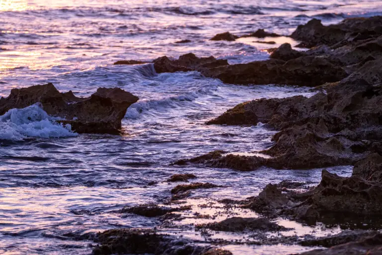 Capture of a stunning sunset with rocks and waves on Moraira's coastline. - Photo by Rafael…