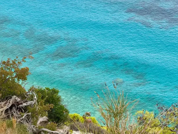 Stunning aerial view of the turquoise waters off the coast of Greece, showcasing natural beauty…