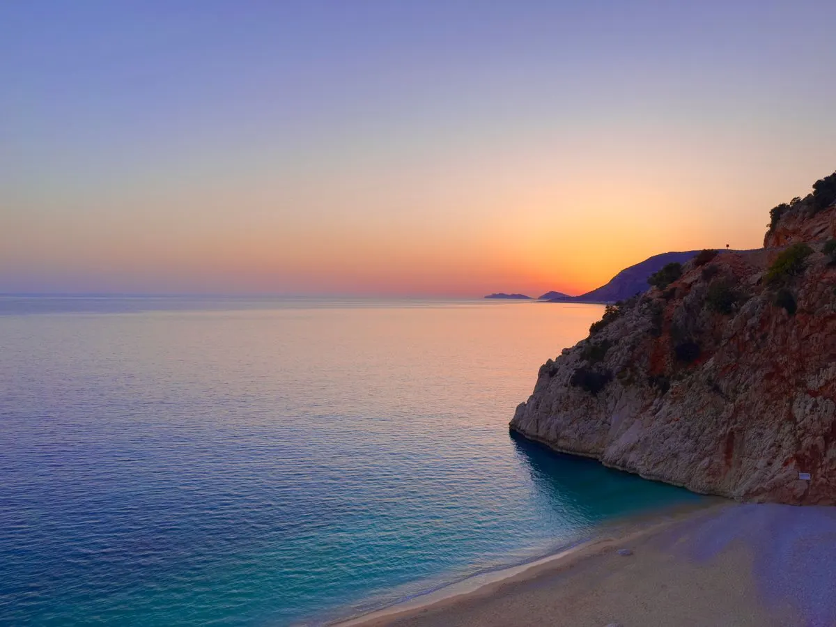 Breathtaking sunset view over the Mediterranean Sea in Antalya, Turkey, showcasing rocky cliffs…