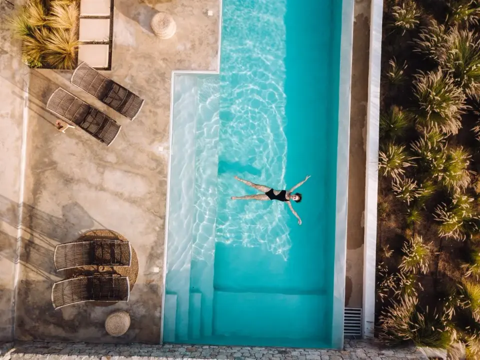 A tropical resort with a luxurious poolside overlooking the ocean, perfect for relaxation and…
