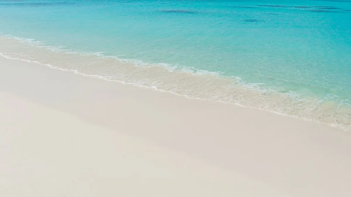 Pristine white sand beach and turquoise waters in the Maldives, exuding tranquility and paradise…
