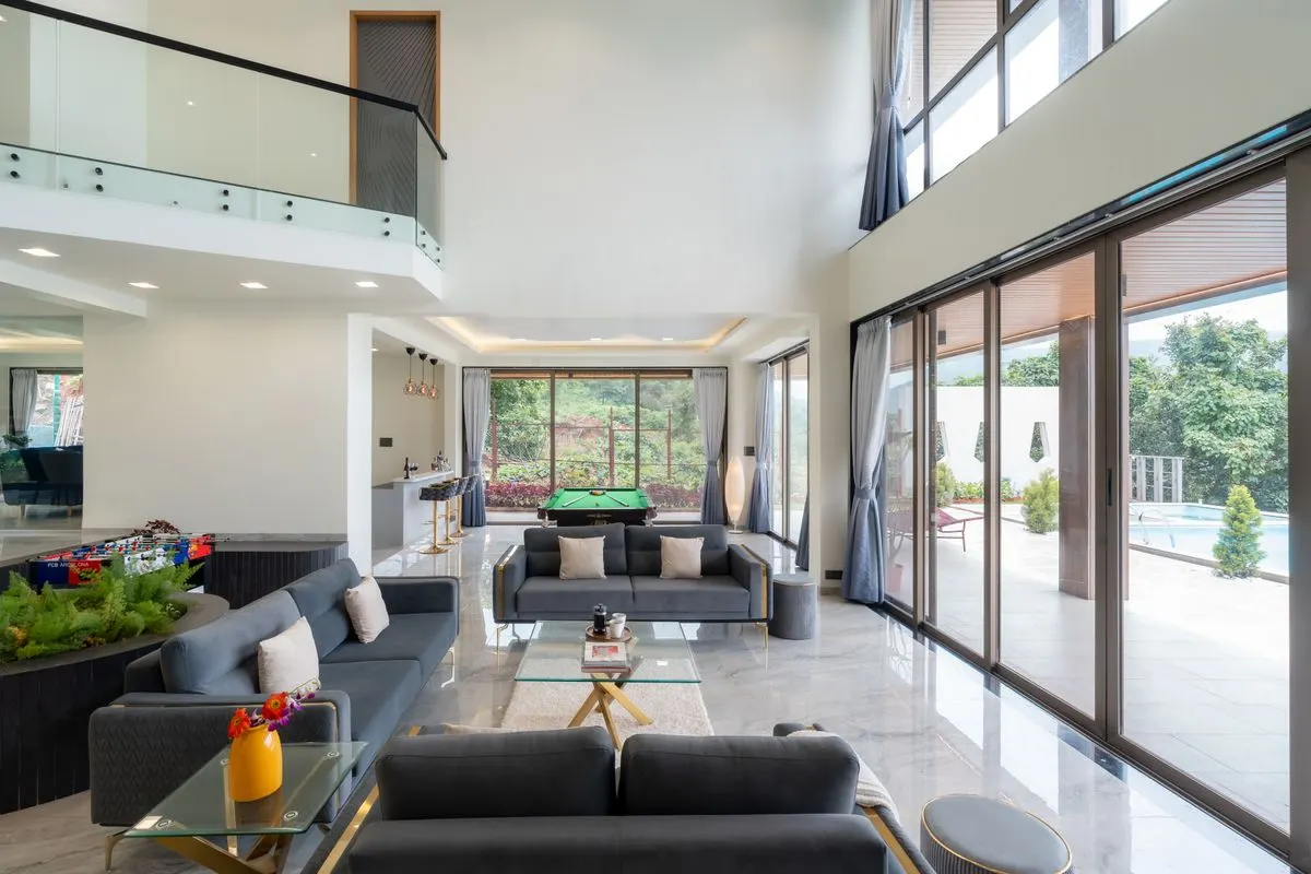 Spacious modern living room with glass walls, open view to pool and garden. - Photo by aksinfo7…
