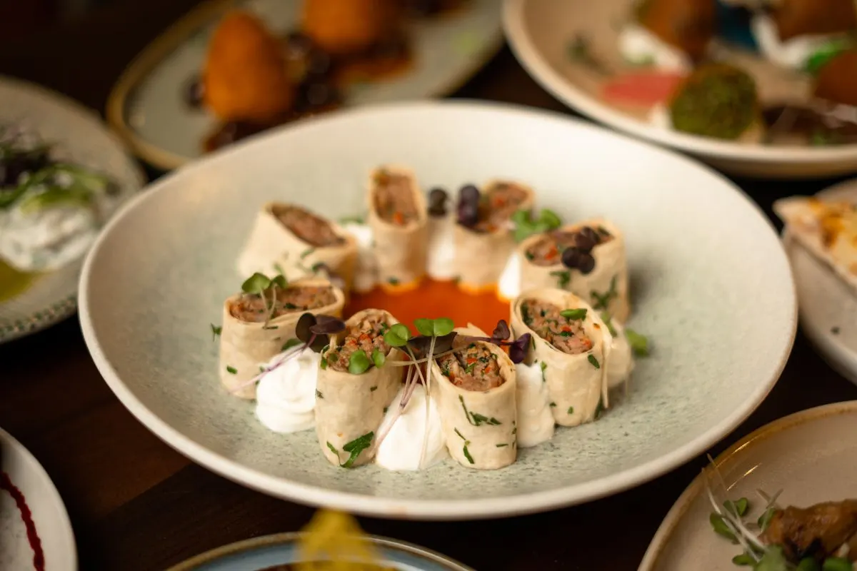 Delicious gourmet wraps with fresh herbs and sauce, perfect for a culinary presentation. - Photo…
