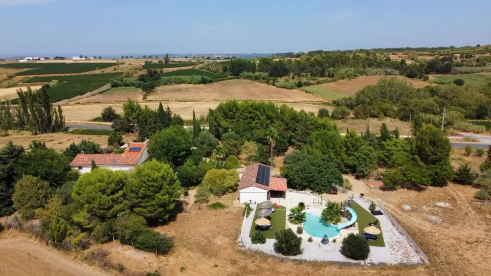 Aerial photograph of a countryside villa with lush greenery and swimming pool. - Photo by…