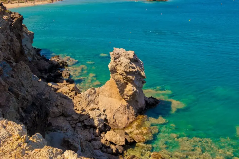 Breathtaking view of a rocky cliff and turquoise sea in Rethymno, Greece. Perfect for summer…